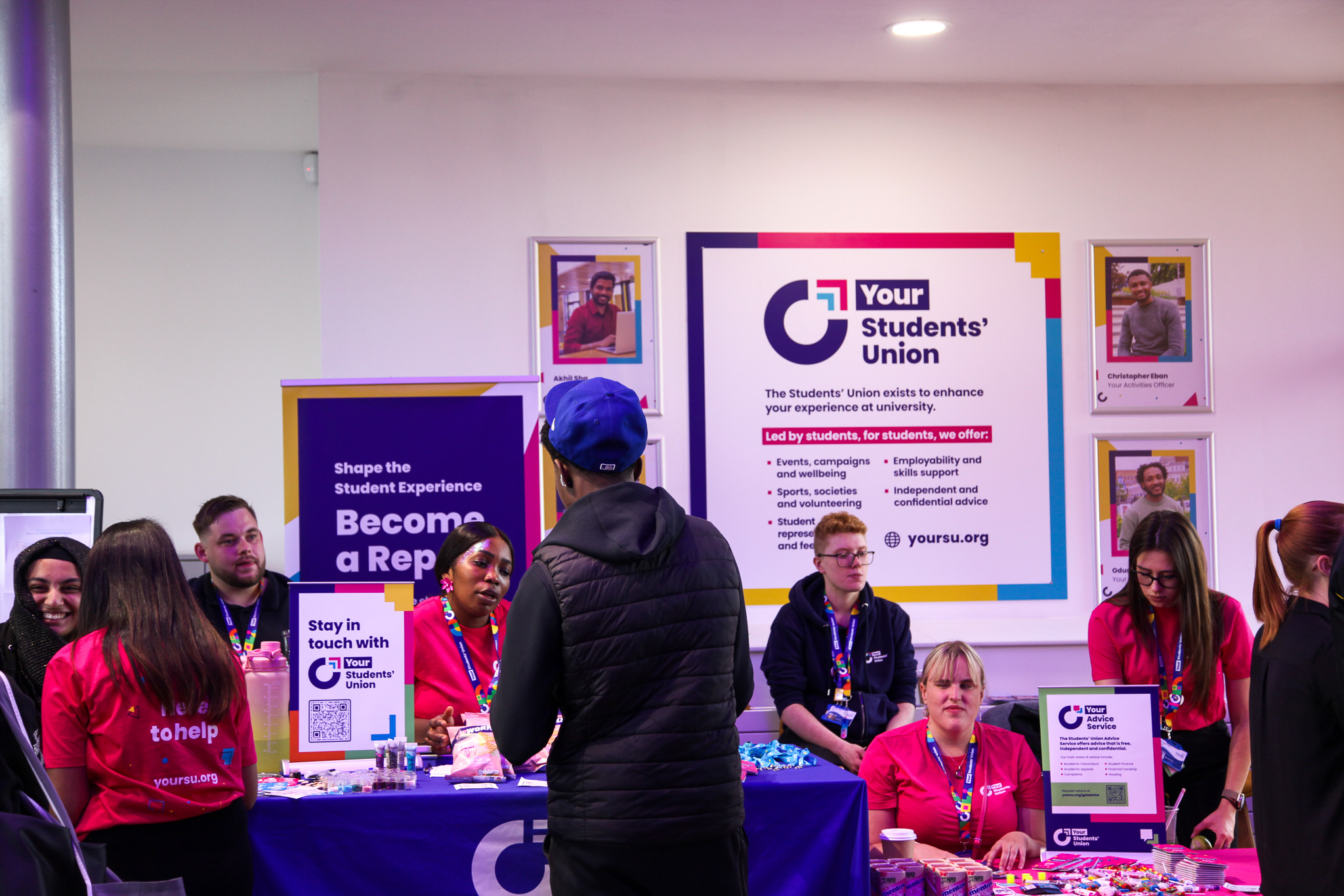 A number of people sat behind tables with Your Student's Union branding.