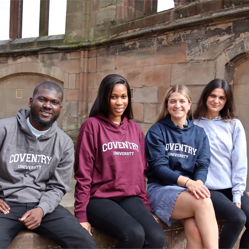 The four part time officers sitting on the wall in Coventry University Clothing