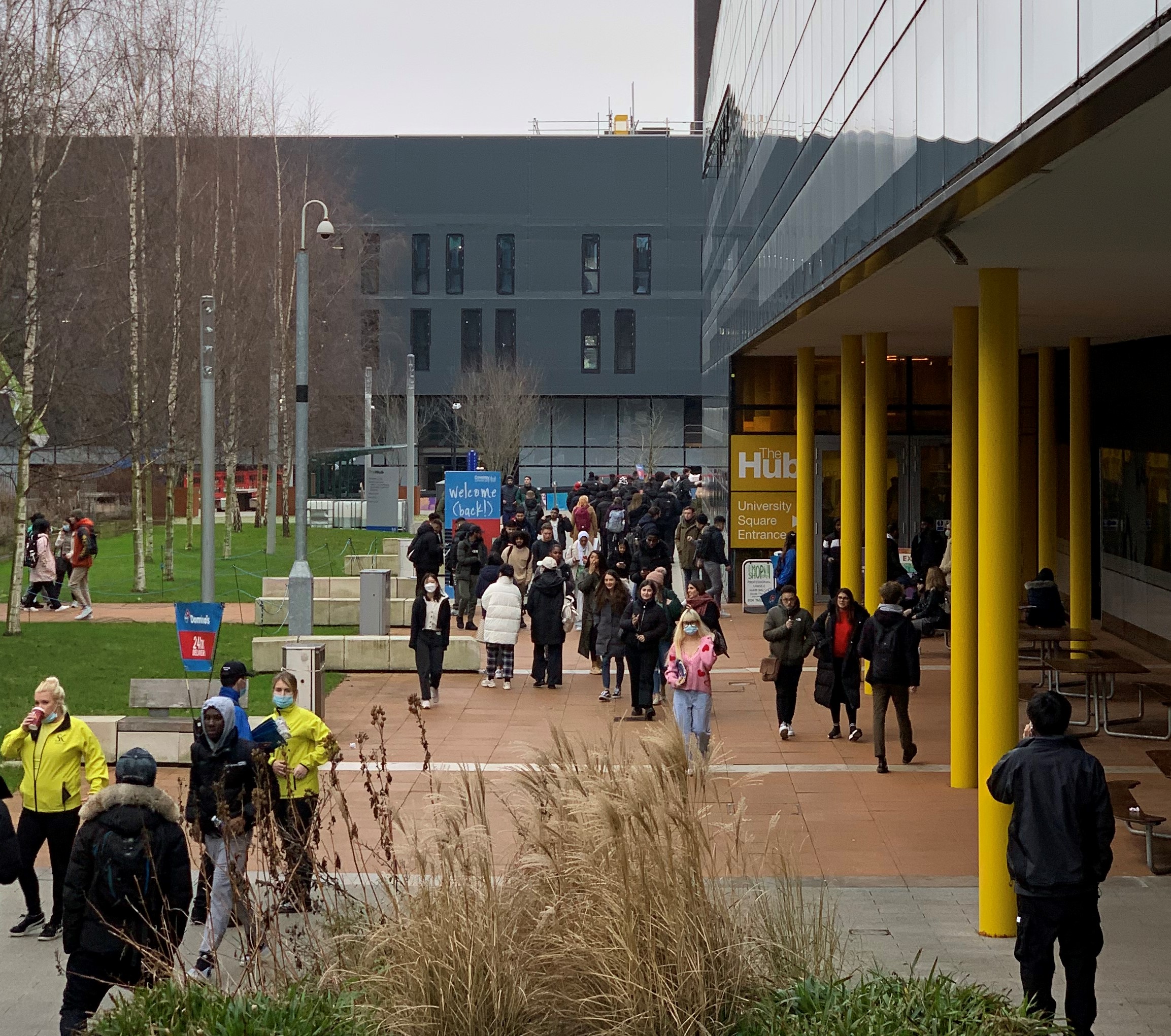 People walking around the hub entrance