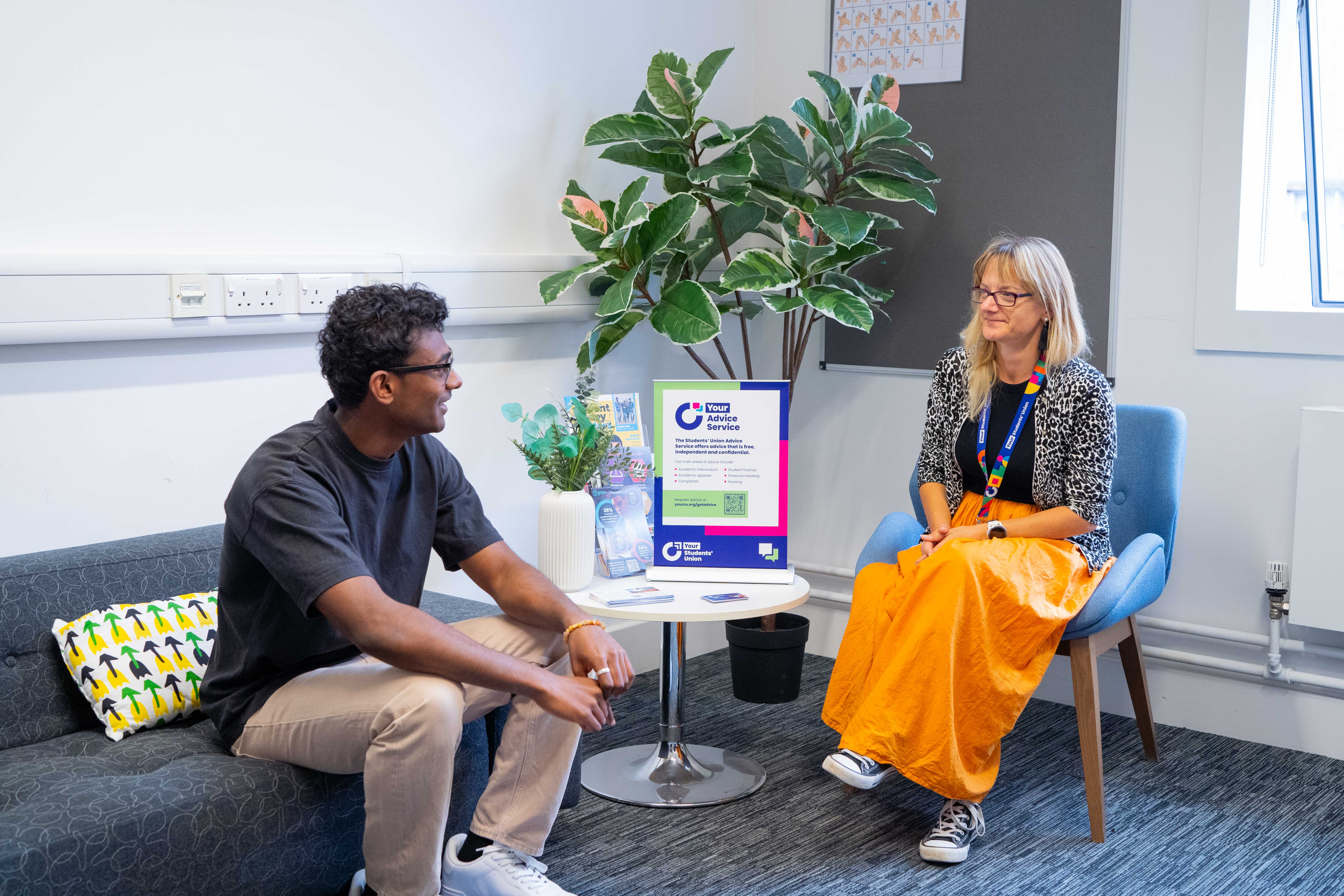 Two people sat down talking.