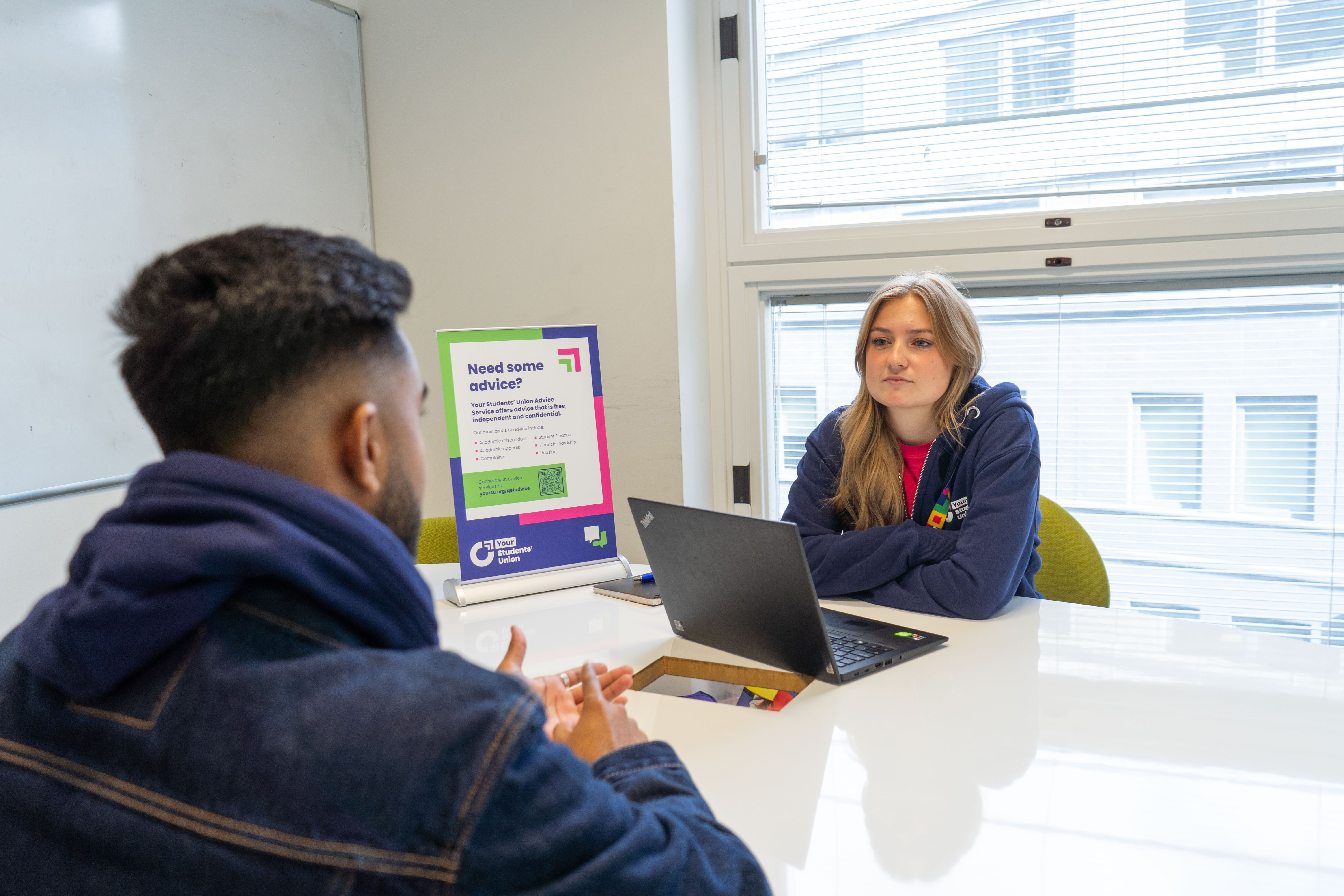 Two people sat down talking.