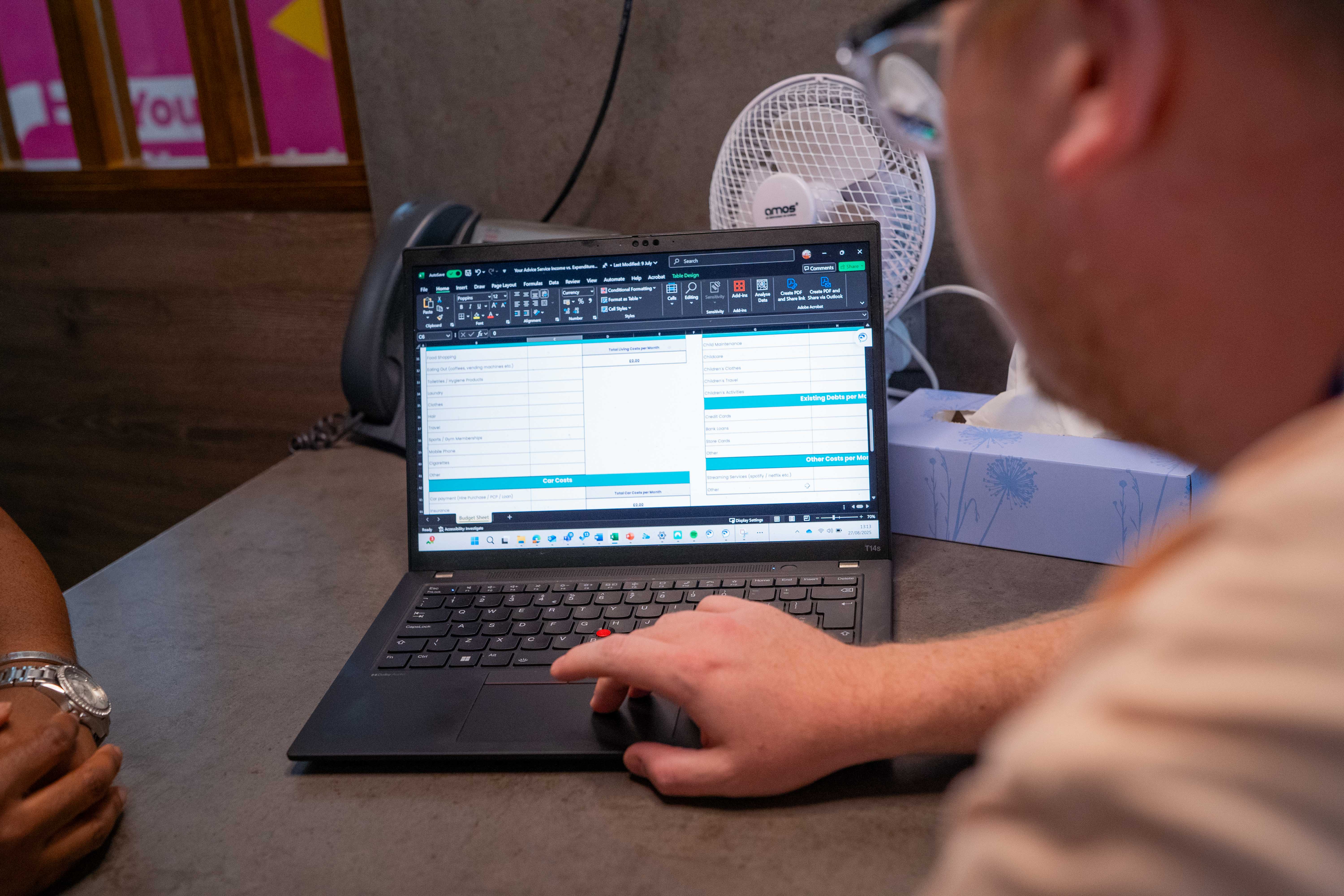 Your Advice staff member going over a financial spreadsheet on a laptop.