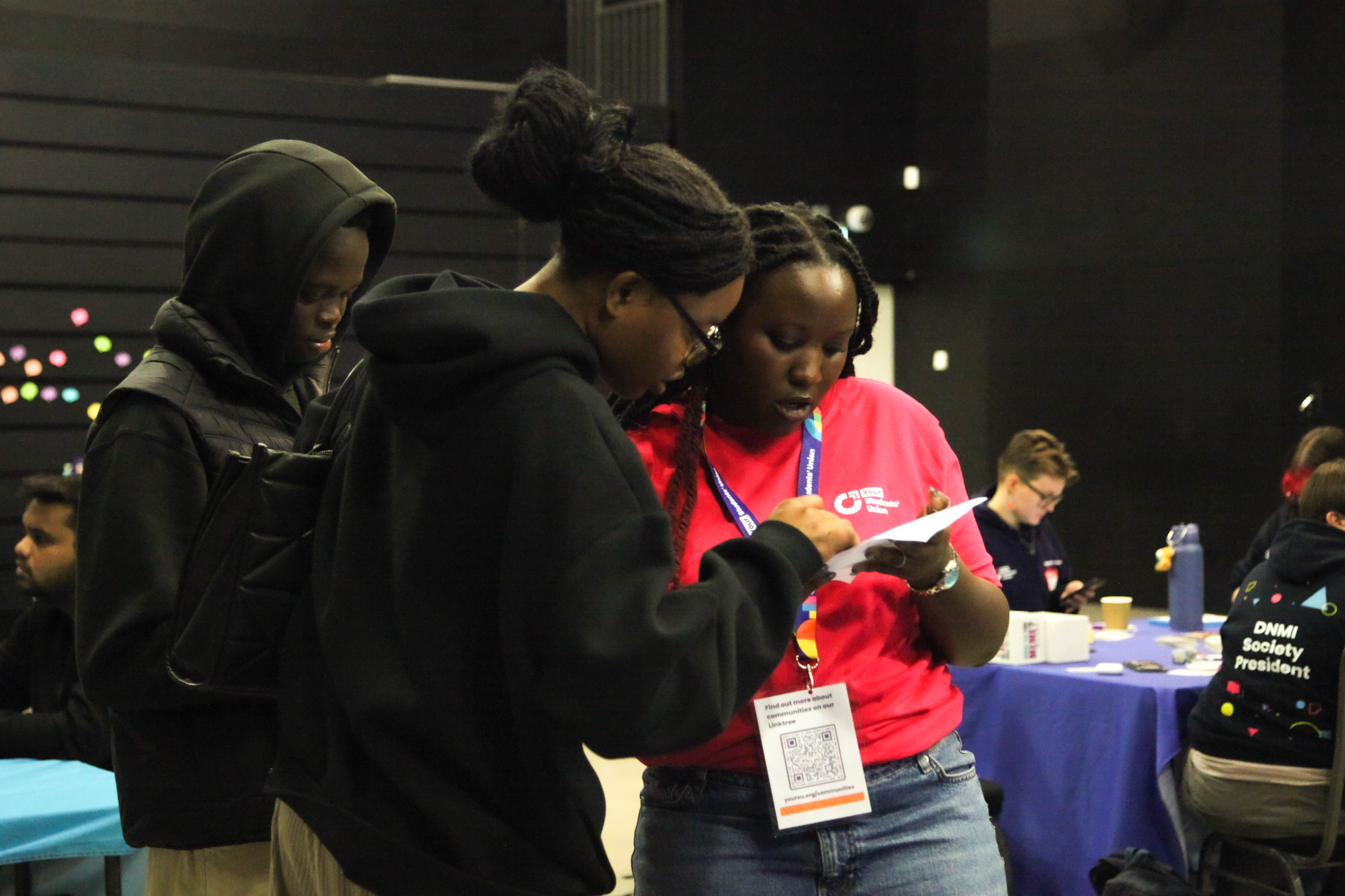 Two people looking at a piece of paper.