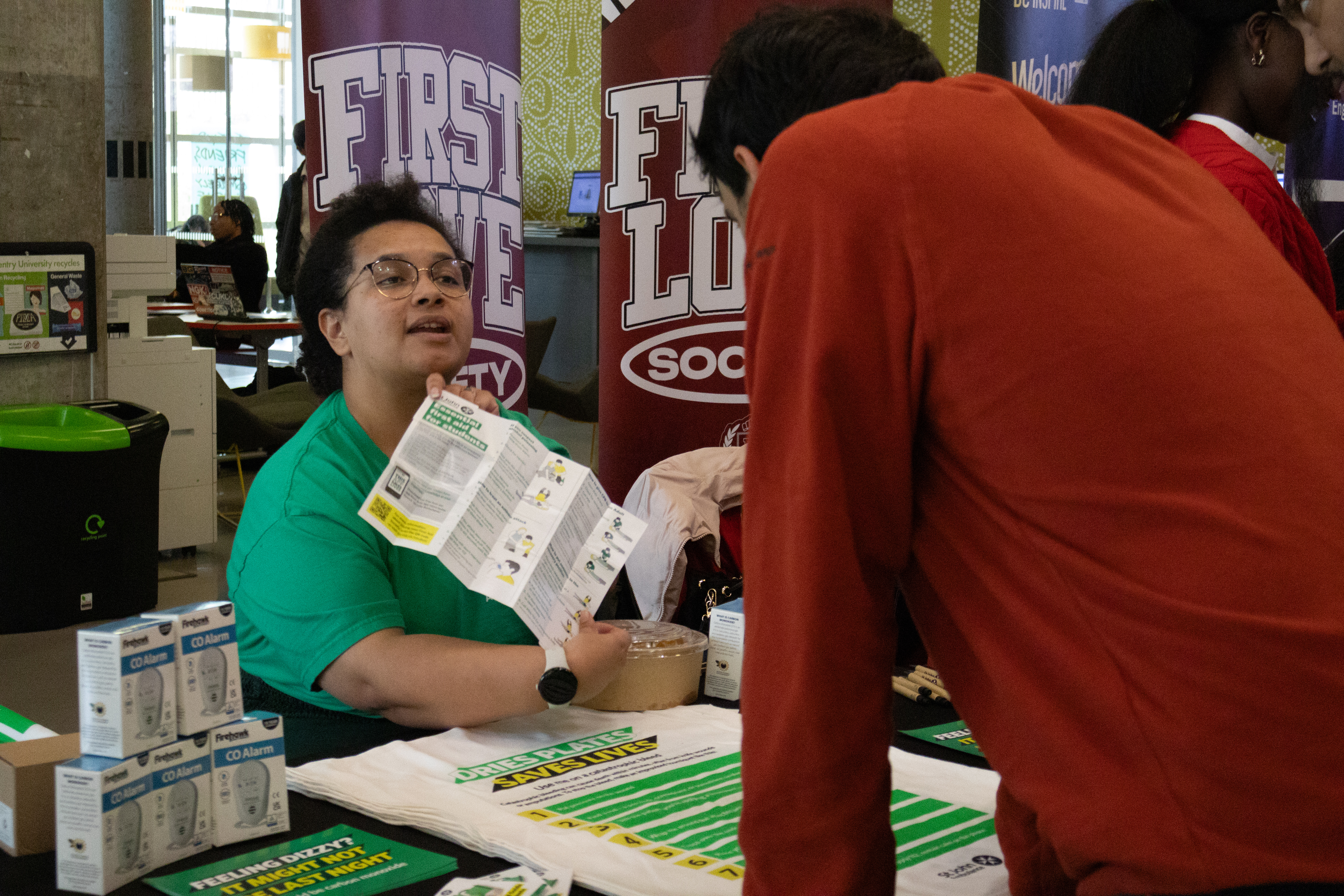 A person from an external organisation showing a person information from a leaflet.