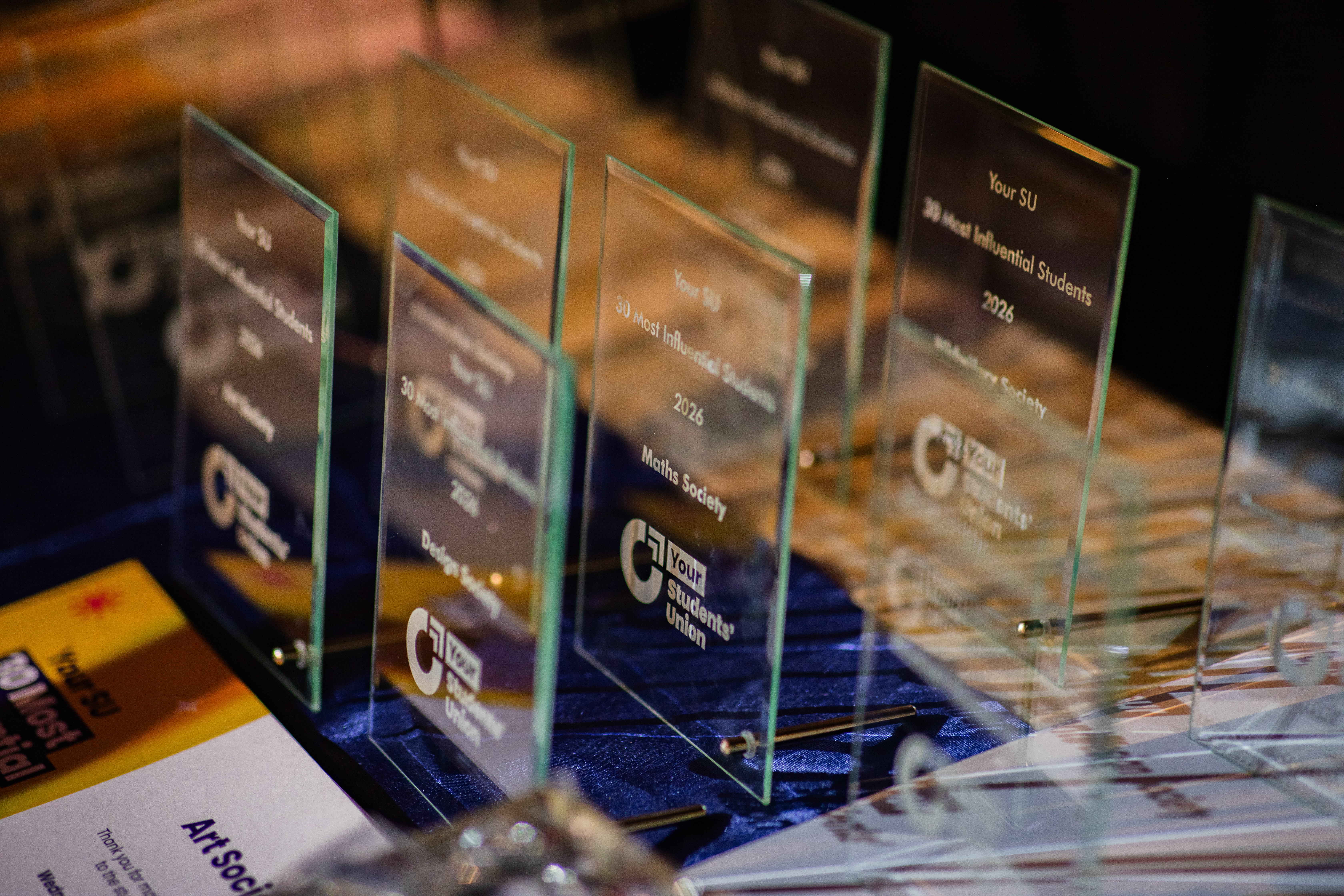 A number of awards placed together on a table.