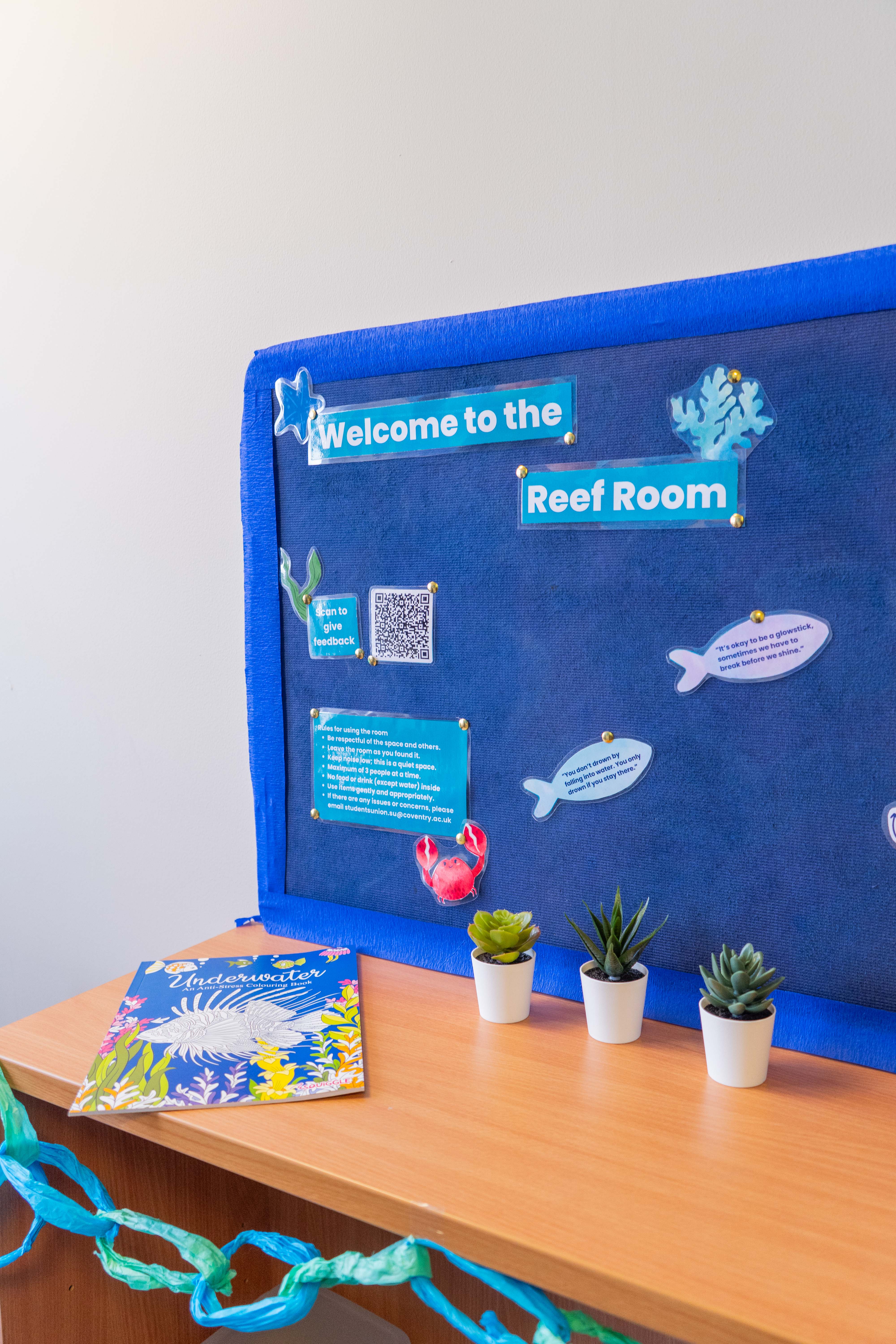 A blue colourful noticeboard.