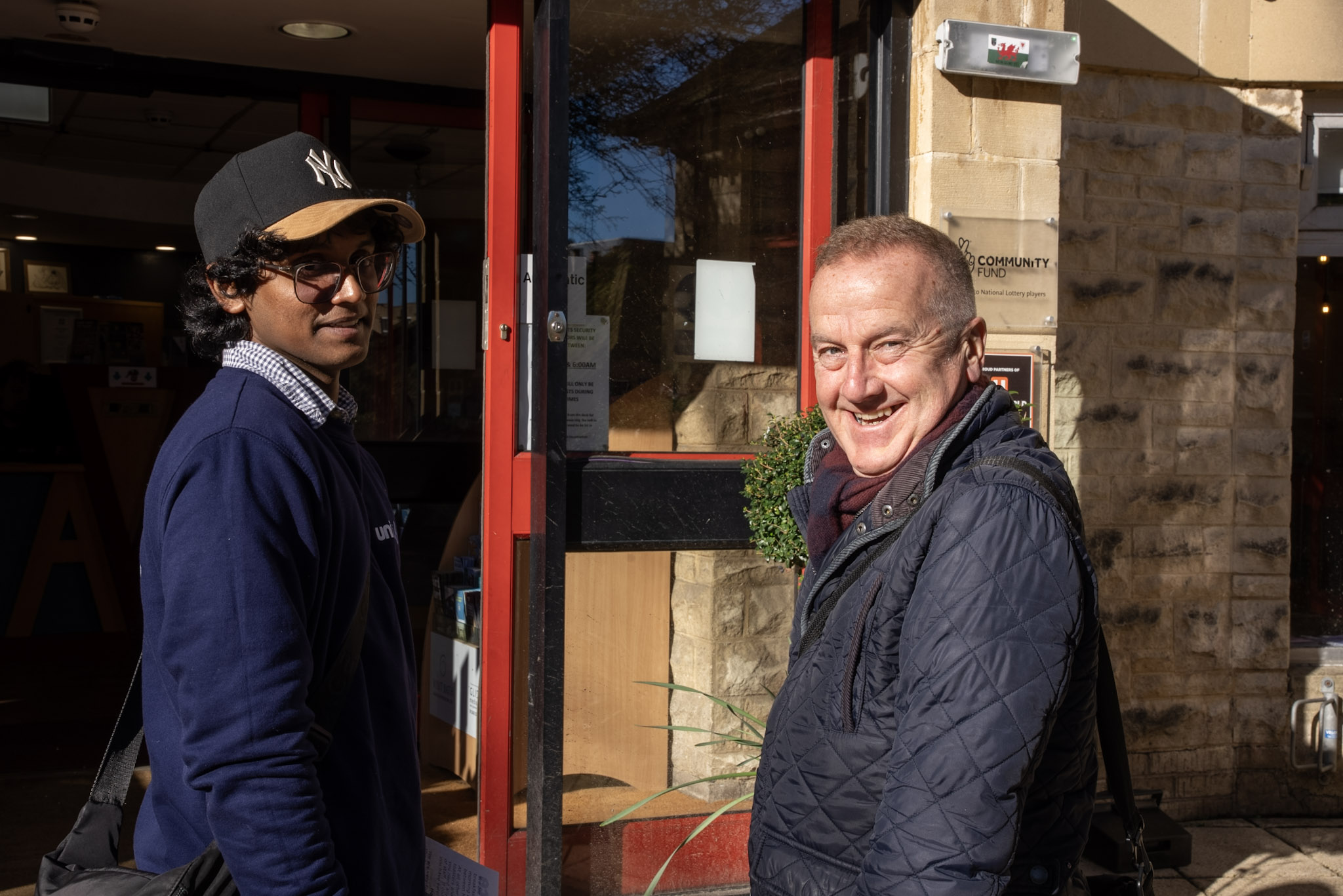 Two people standing and looking at the camera.