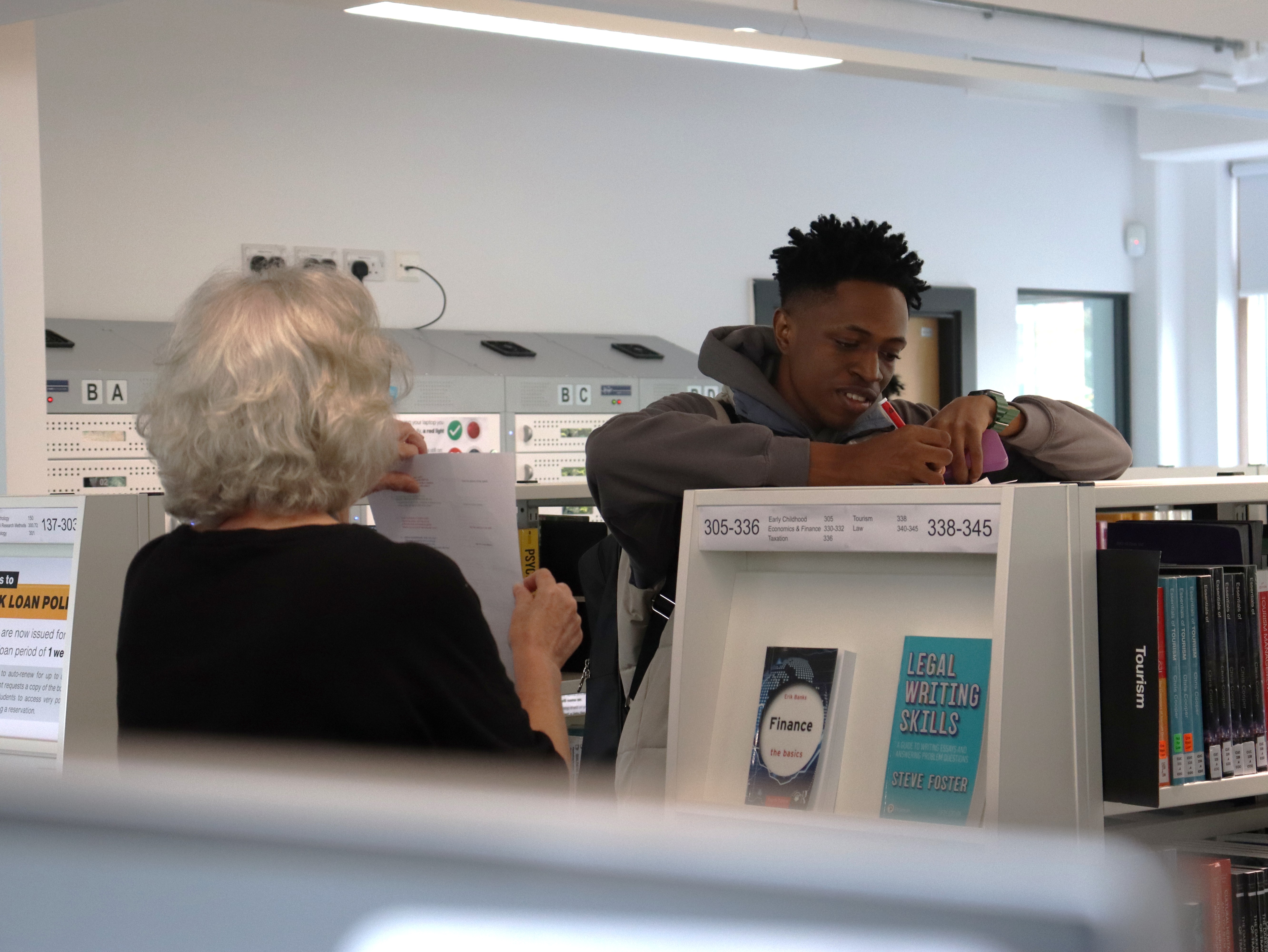 A person writing on a piece of paper.