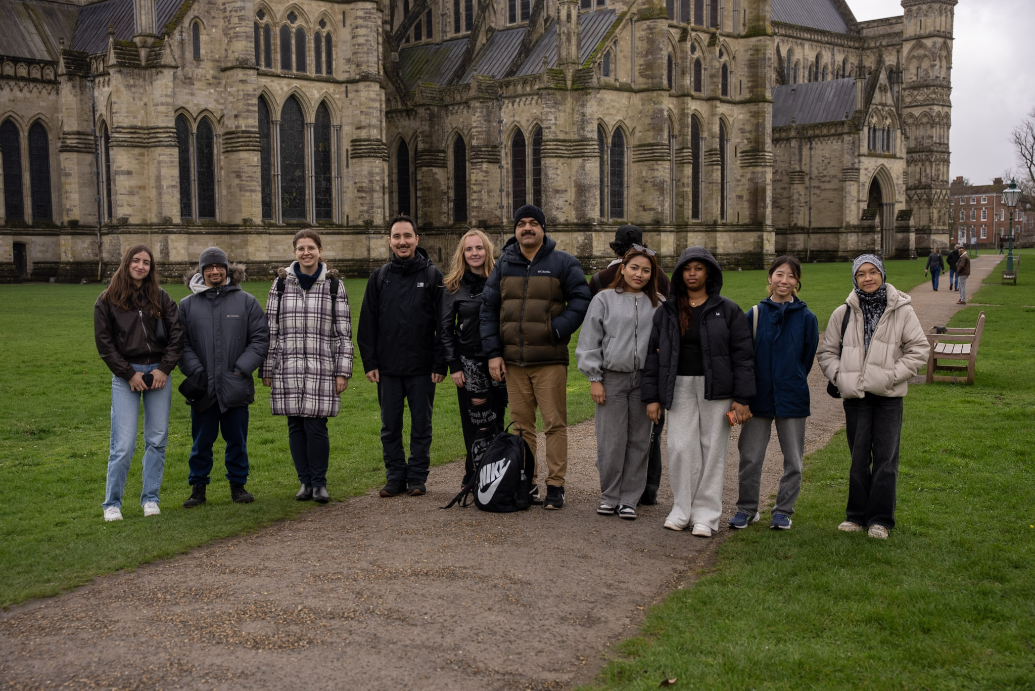 A group of people standing outside of a cathedral.