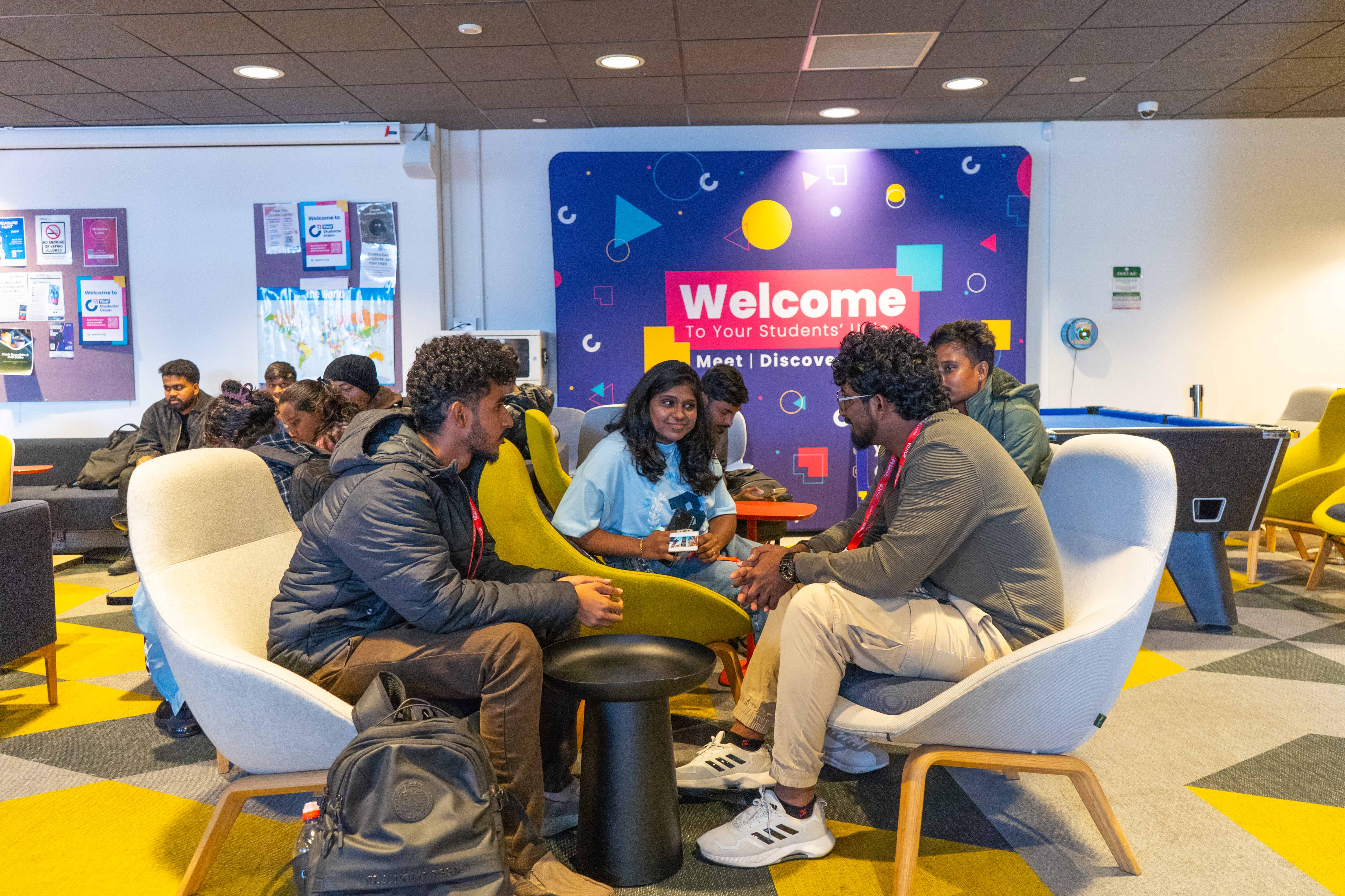 People sat around a table talking.