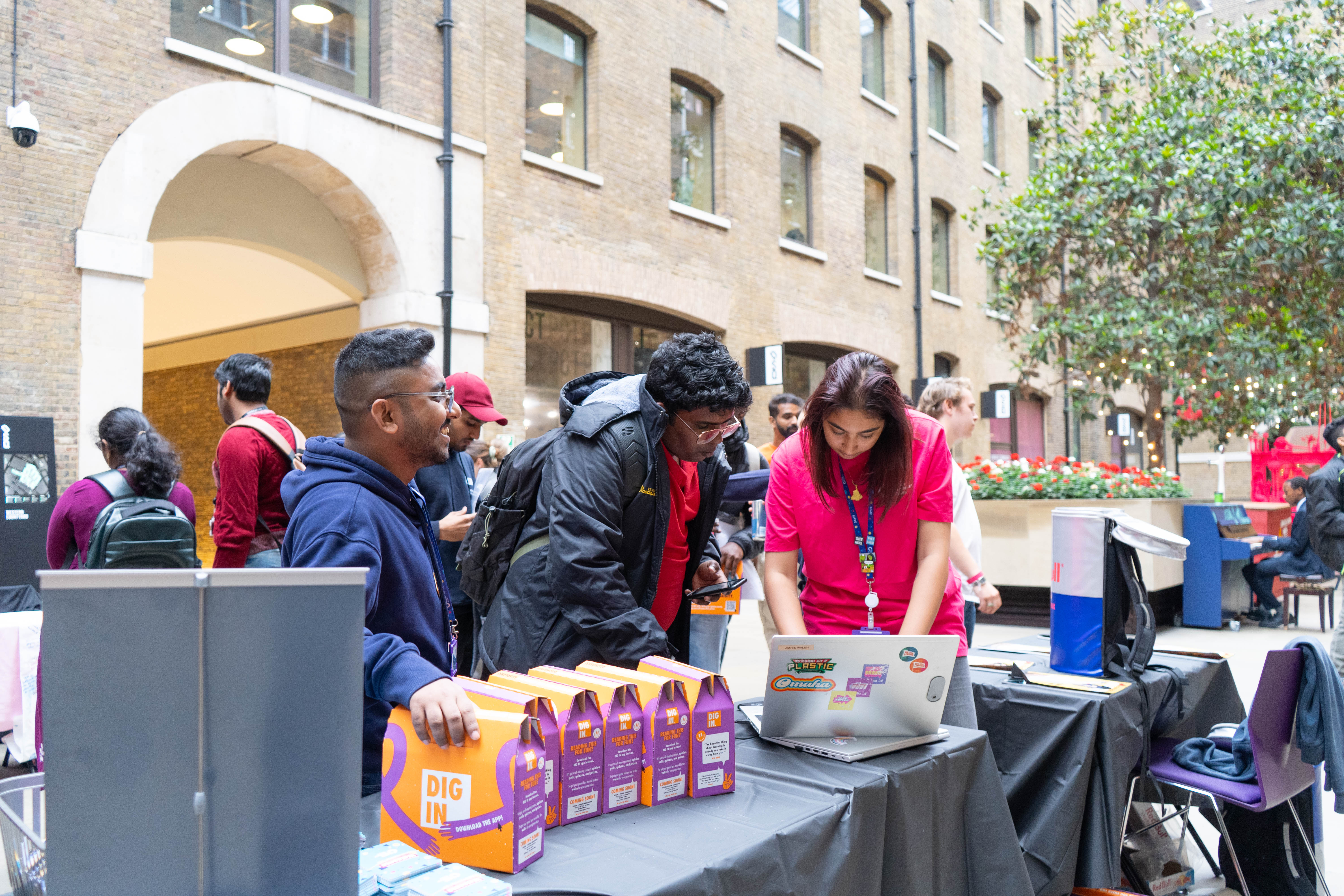 People looking at a laptop screen.