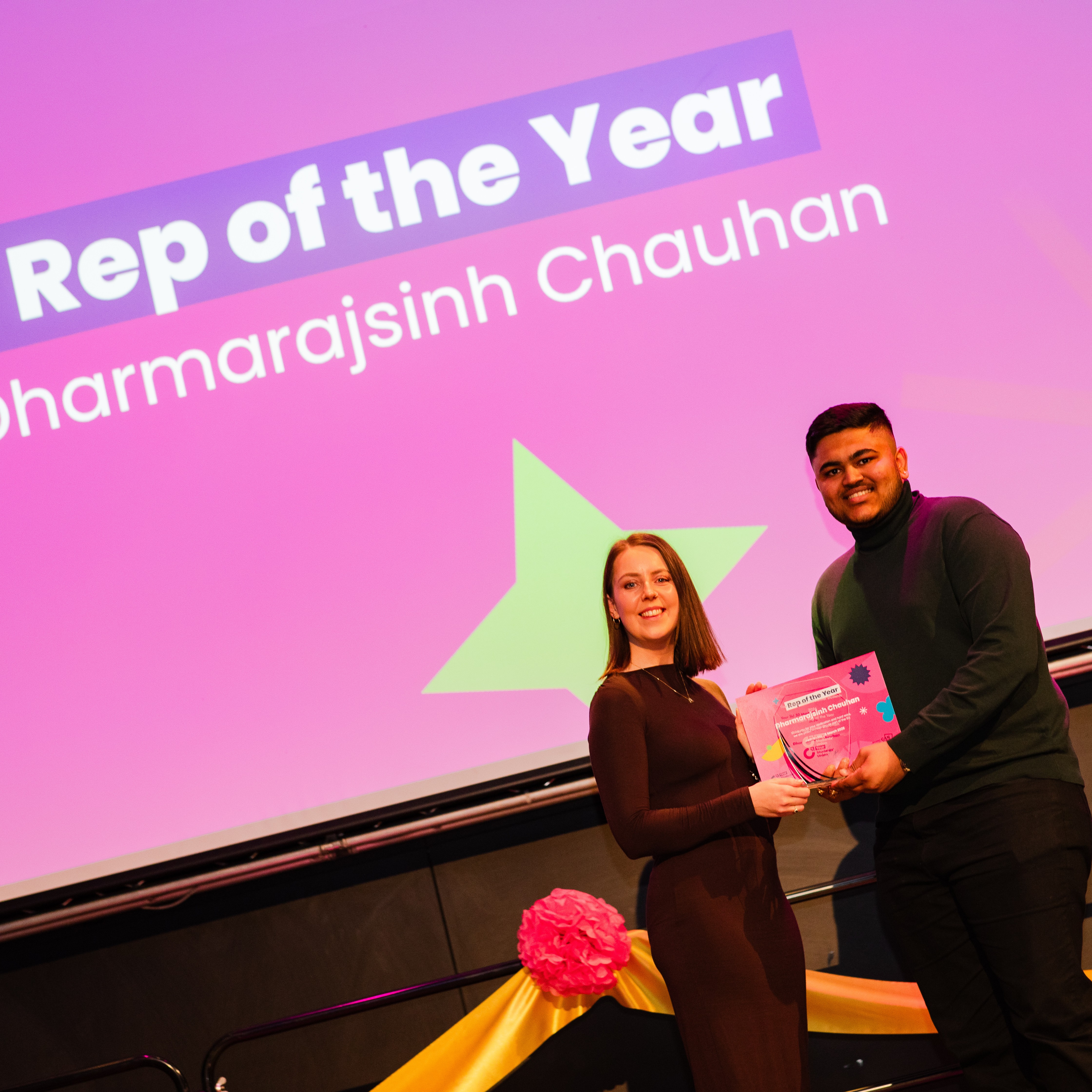 A person being handed a Rep of the Year award at the Top 30 Most Influential Students awards evening.