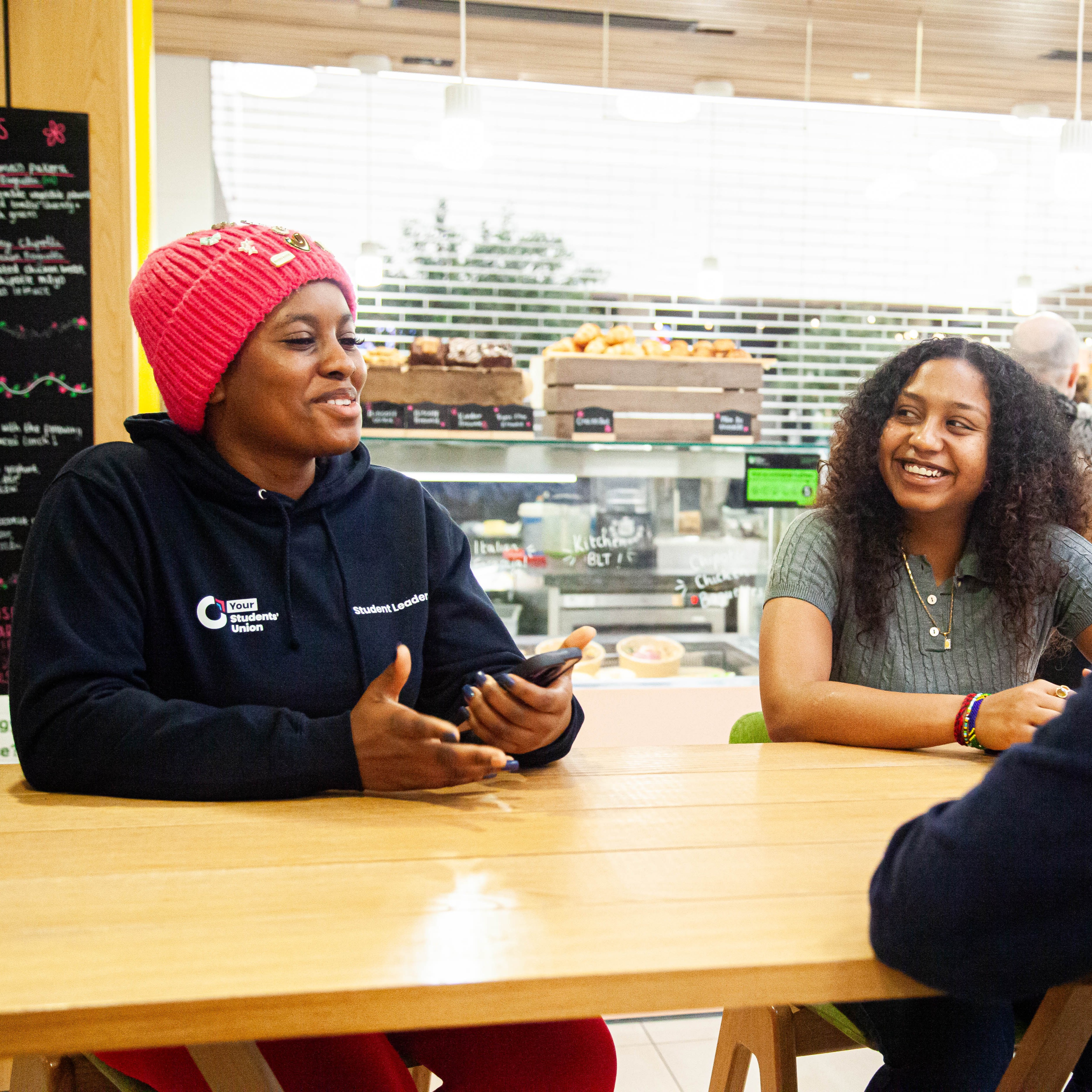 Two people sitting down at a table talking.