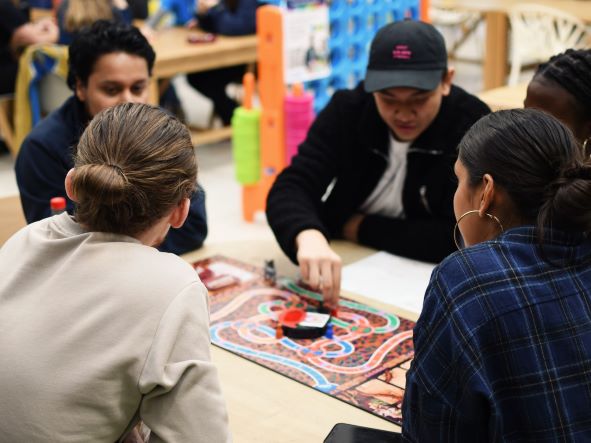 Students playing board game
